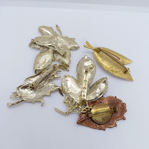 801 - A gilt metal leaf brooch, and four others (5)