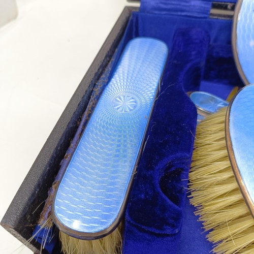 806 - A George V silver and blue enamel dressing table set, comprising a mirror, four brushes, a comb, a s... 