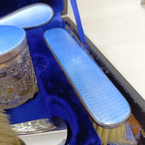 806 - A George V silver and blue enamel dressing table set, comprising a mirror, four brushes, a comb, a s... 