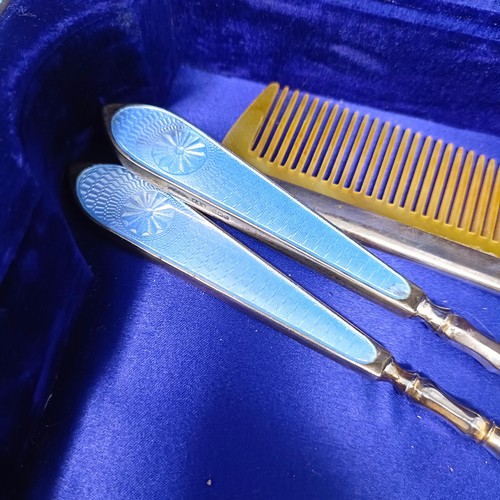 806 - A George V silver and blue enamel dressing table set, comprising a mirror, four brushes, a comb, a s... 