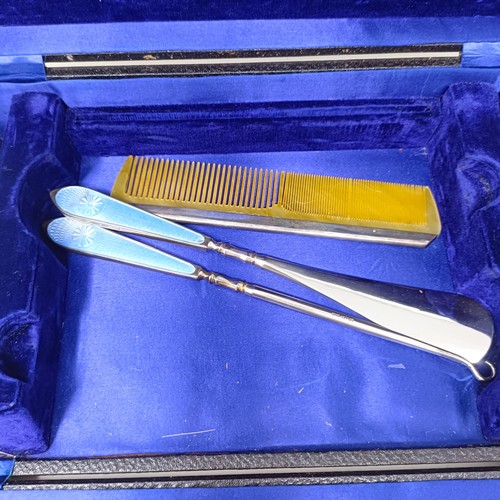 806 - A George V silver and blue enamel dressing table set, comprising a mirror, four brushes, a comb, a s... 