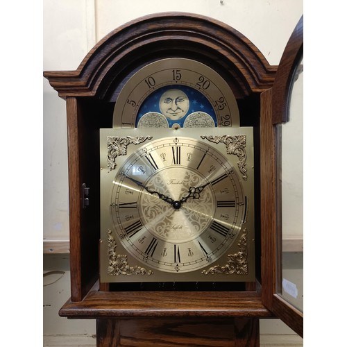 895 - A modern longcase clock, in an oak case, 180 cm high