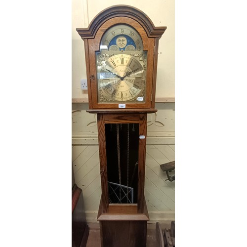 895 - A modern longcase clock, in an oak case, 180 cm high