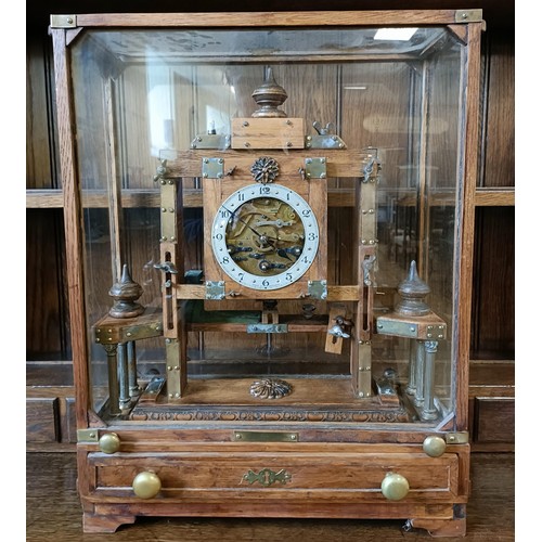 897 - An unusual mantel clock, the silvered dial fitted an eight day triple train movement, striking on a ... 