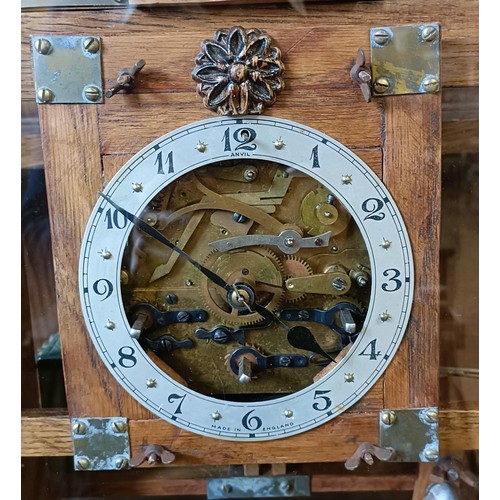 897 - An unusual mantel clock, the silvered dial fitted an eight day triple train movement, striking on a ... 