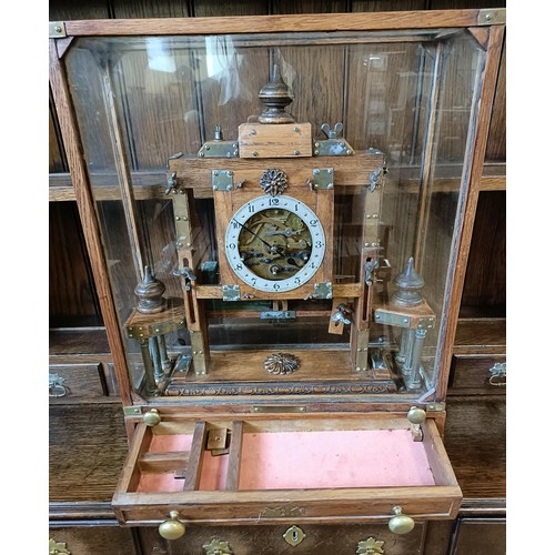 897 - An unusual mantel clock, the silvered dial fitted an eight day triple train movement, striking on a ... 