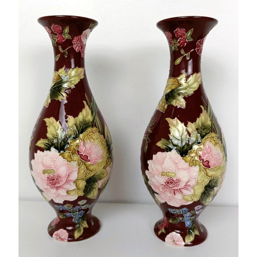 611 - A pair of red ground vases, decorated flowers, 27 cm high, a silver plated and wooden fruit bowl, an... 