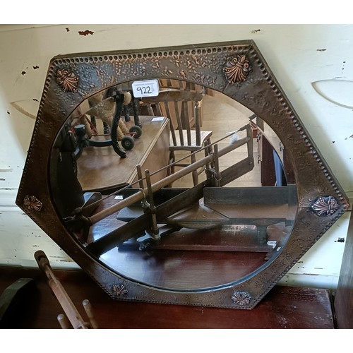 922 - A mirror, in a copper frame, 52 cm diameter, and a saw (2)