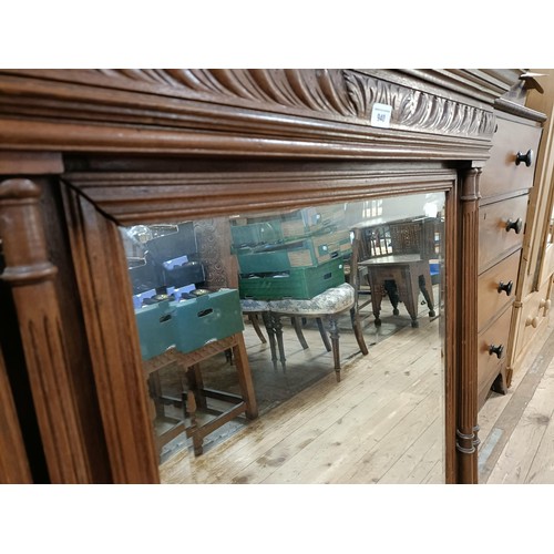 940 - A French wall mirror, in a walnut frame, 132 x 88 cm