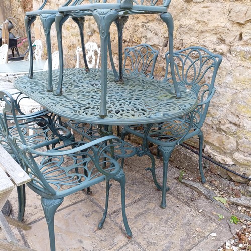 1078 - A painted metal garden table, 147 cm wide, six chairs, a folding table and an umbrella stand