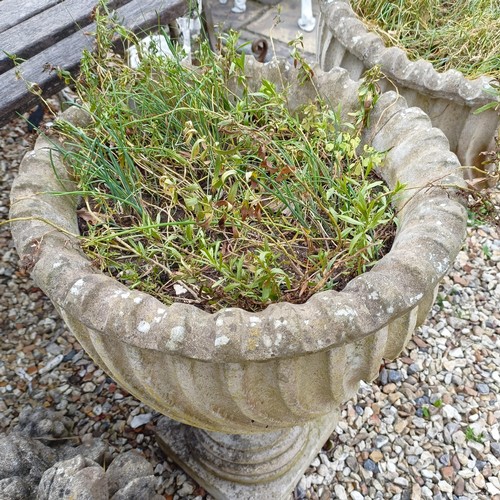 1075 - A pair of composite stone garden urns, 48 cm diameter