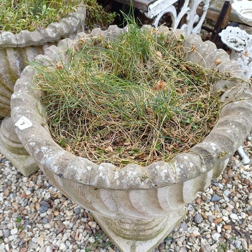 1075 - A pair of composite stone garden urns, 48 cm diameter