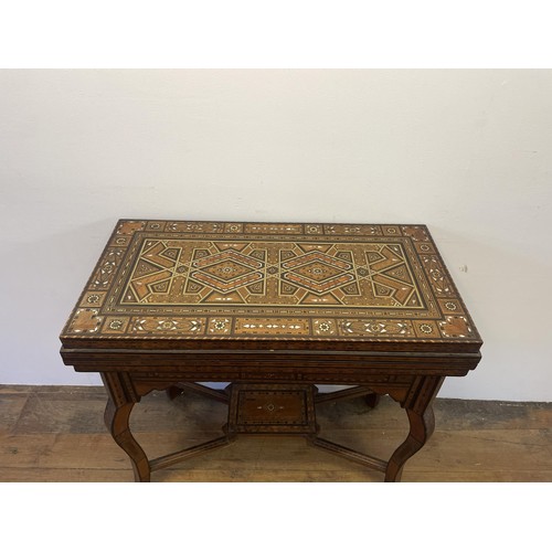 951 - A Syrian hardwood games table with parquetry and mother of pearl inlaid, 83 cm wide