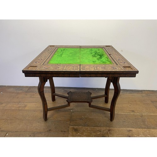 951 - A Syrian hardwood games table with parquetry and mother of pearl inlaid, 83 cm wide