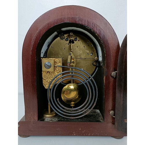 878 - A mantel clock, in a red marble and slate case, 33 cm wide, and three other clocks (4)