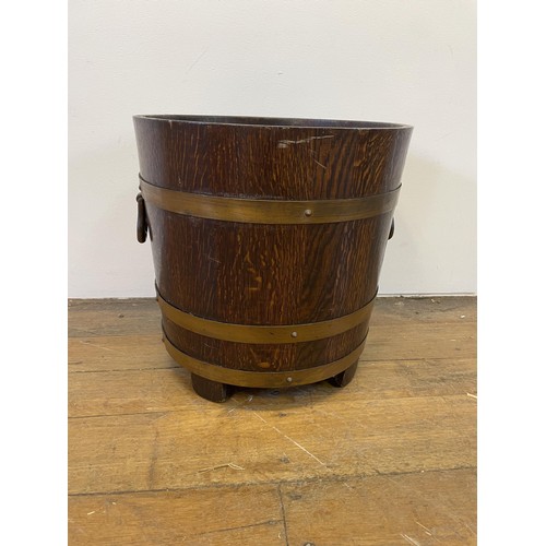 976 - An oak and copper bound coal bucket, with a makers label for R A Lister & Co., 48 cm