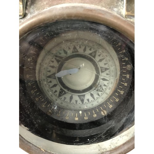 858 - A ship's barometer, by J N Taylor & Co, Adelaide, in a brass case with a mahogany mount, 24 cm d... 