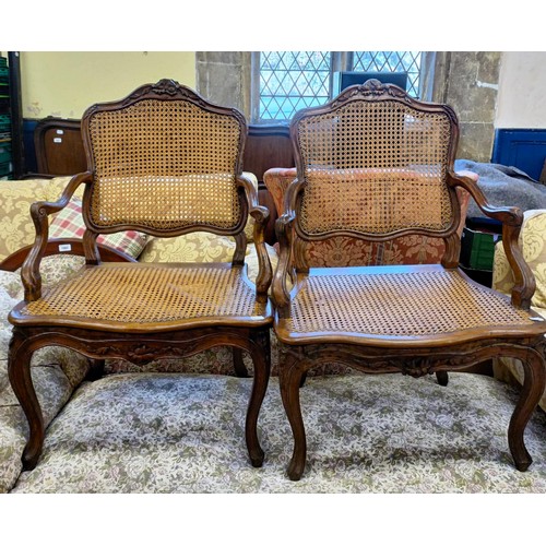 1066 - A pair of French walnut framed bergere armchairs (2)