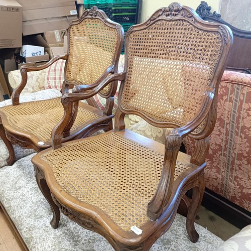 1066 - A pair of French walnut framed bergere armchairs (2)