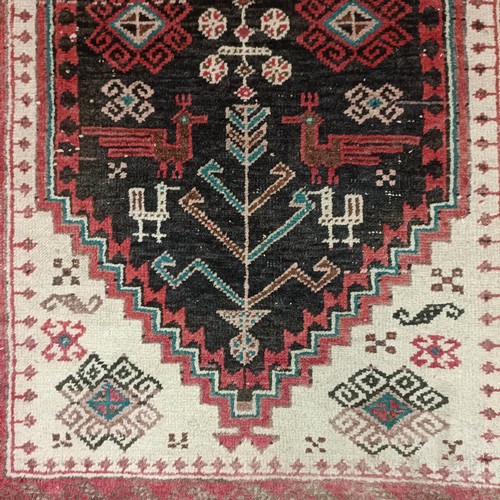 1085 - A red ground rug, 188 x 108 cm