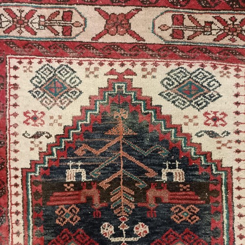 1085 - A red ground rug, 188 x 108 cm