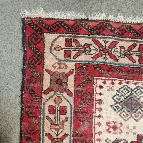 1085 - A red ground rug, 188 x 108 cm