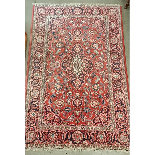 1084 - A red ground rug, 200 x 130 cm