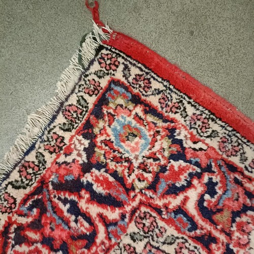 1084 - A red ground rug, 200 x 130 cm