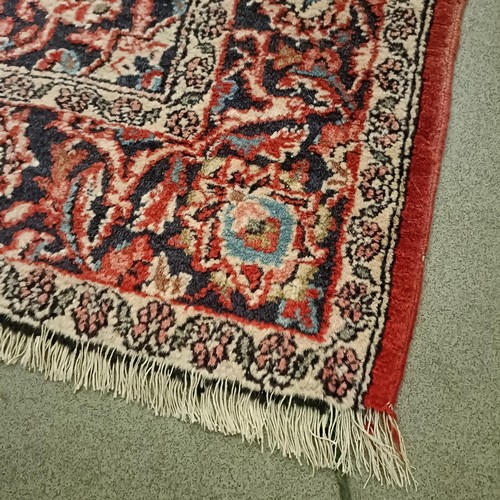 1084 - A red ground rug, 200 x 130 cm