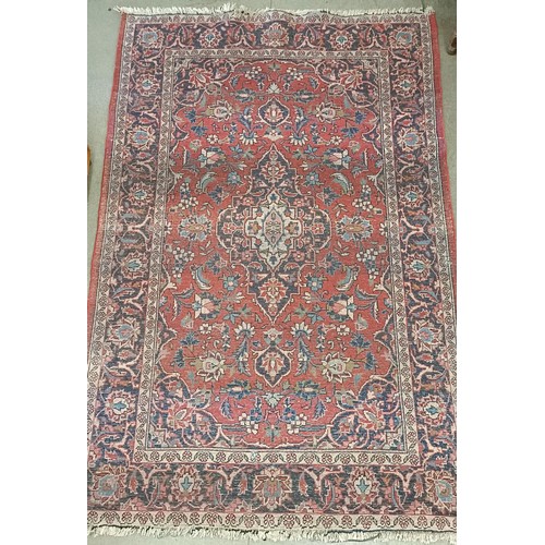 1084 - A red ground rug, 200 x 130 cm