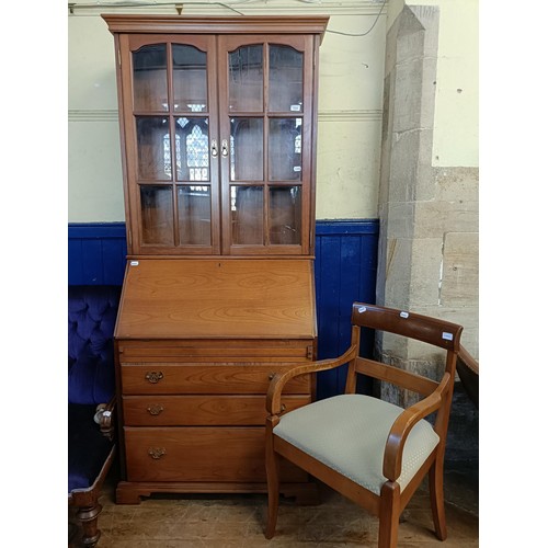 1059 - A yew wood bureau bookcase, and an armchair (2)