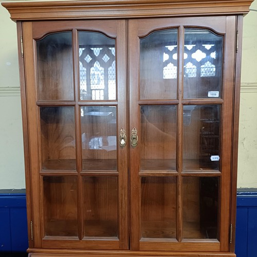 1059 - A yew wood bureau bookcase, and an armchair (2)