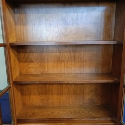 1059 - A yew wood bureau bookcase, and an armchair (2)