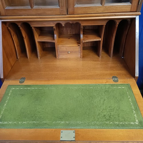 1059 - A yew wood bureau bookcase, and an armchair (2)