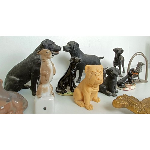 673 - A silver plated figure of a dog, in a horseshoe, and assorted other dog figures