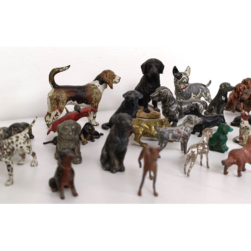 677 - A silver plated figure of a dachshund, 7 cm wide, and assorted other dog figures (qty)