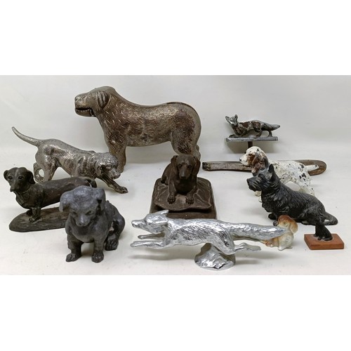 679 - A silver plated figure of a crouching dog, 16 cm wide, and assorted other figures of dogs (qty)