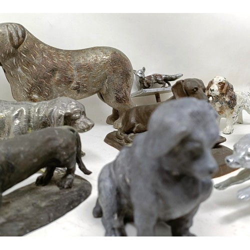 679 - A silver plated figure of a crouching dog, 16 cm wide, and assorted other figures of dogs (qty)