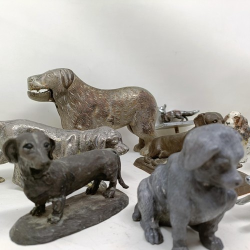 679 - A silver plated figure of a crouching dog, 16 cm wide, and assorted other figures of dogs (qty)