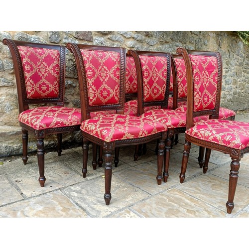 947 - A set of eight mahogany framed dining chairs with padded backs and seats