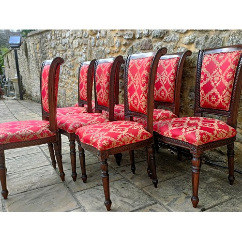 947 - A set of eight mahogany framed dining chairs with padded backs and seats