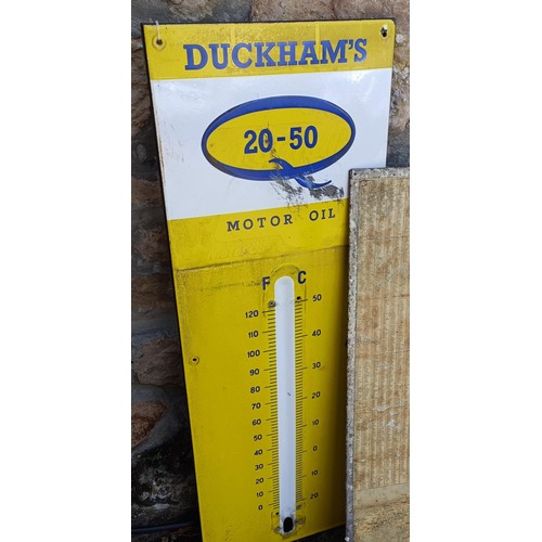 109 - A Duckhams Oil enamel forecourt thermometer, a road map 76 x 92 cm, and another sign (3)