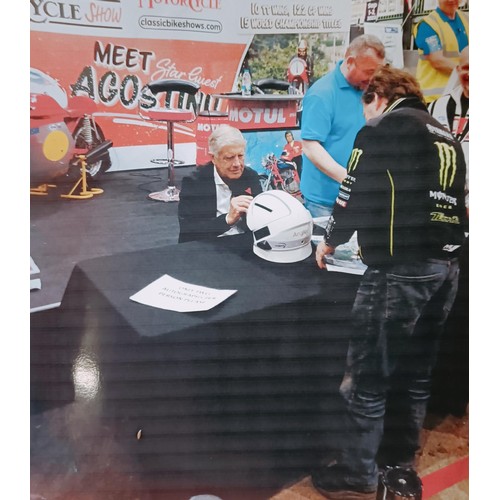 41 - A marshalls helmet, signed by Agostini for the owner, with a photo of the helmet being signed