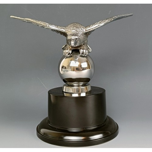 379 - A Desmo accessory car mascot, in the form of an eagle on a ball, chrome plated, on a modern base, 16... 