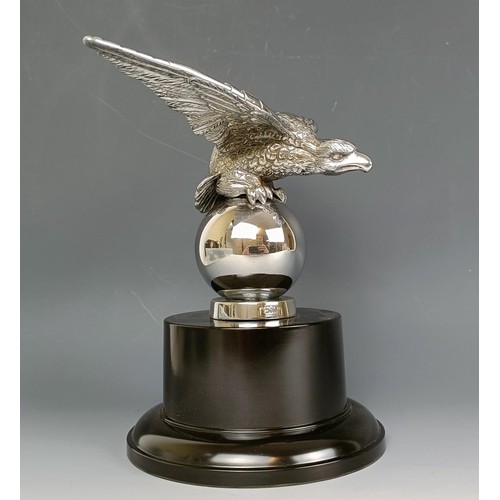 379 - A Desmo accessory car mascot, in the form of an eagle on a ball, chrome plated, on a modern base, 16... 