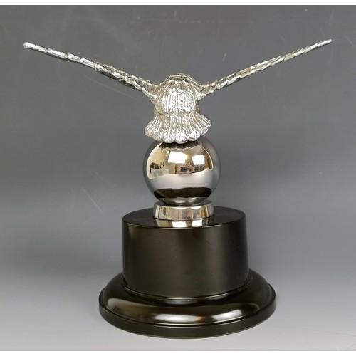 379 - A Desmo accessory car mascot, in the form of an eagle on a ball, chrome plated, on a modern base, 16... 