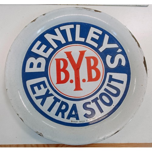 207 - An enamel sign, W.C., 40 cm wide, and an enamel beer tray, Bentley's Extra Stout, 30 cm diameter (2)... 