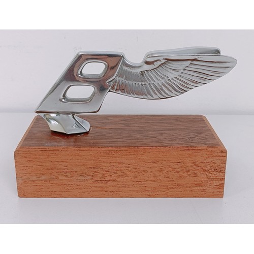 456 - A Bentley backwards leaning Winged B mascot, 5.5 cm high, mounted on a wooden block