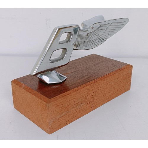 456 - A Bentley backwards leaning Winged B mascot, 5.5 cm high, mounted on a wooden block