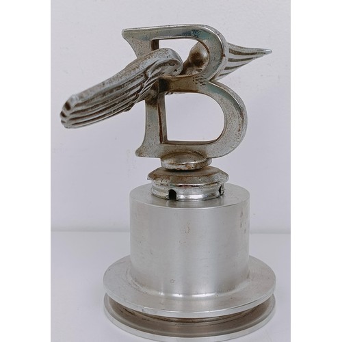 457 - A Bentley Winged B mascot, repaired, 23 cm wingspan, on a modern stand